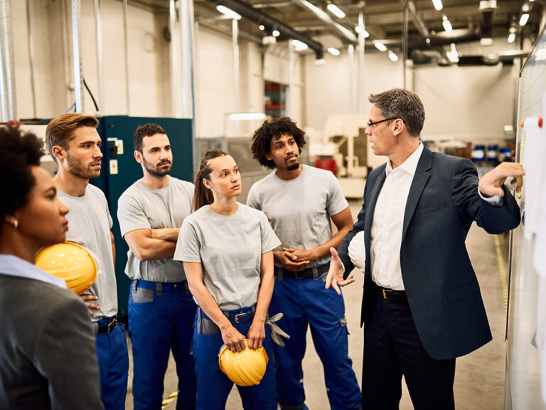team discussing AI in Manufacturing